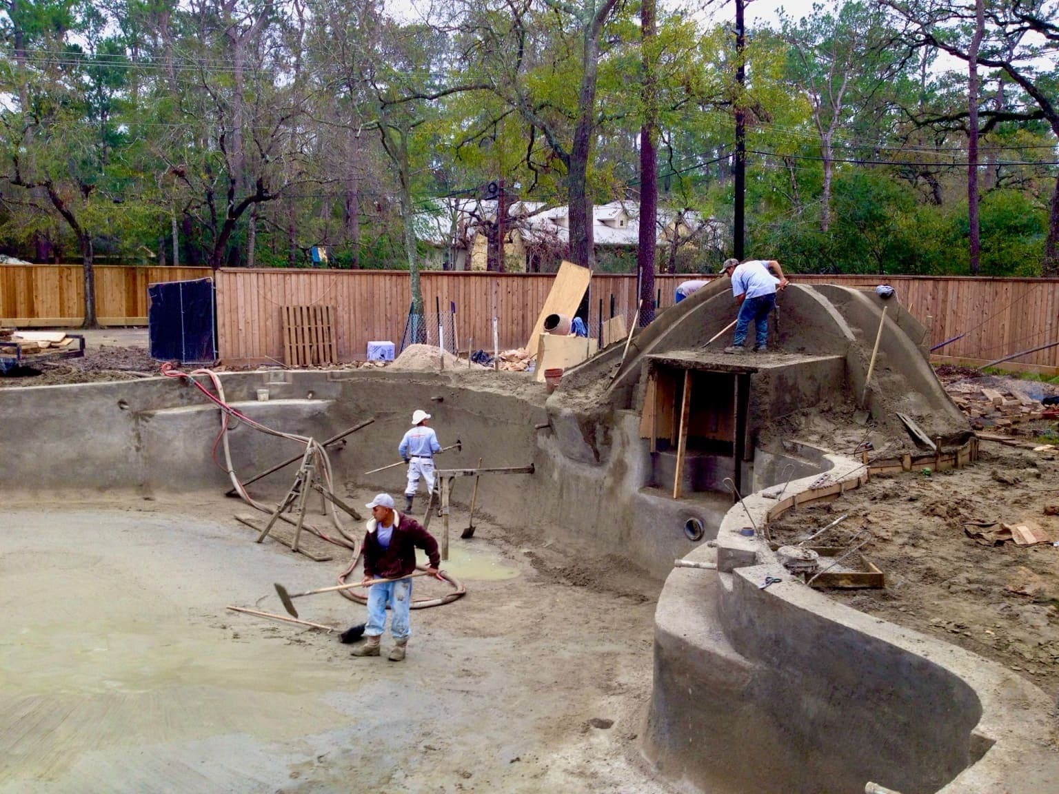 Artificial rock waterfall feature beside a gunite pool