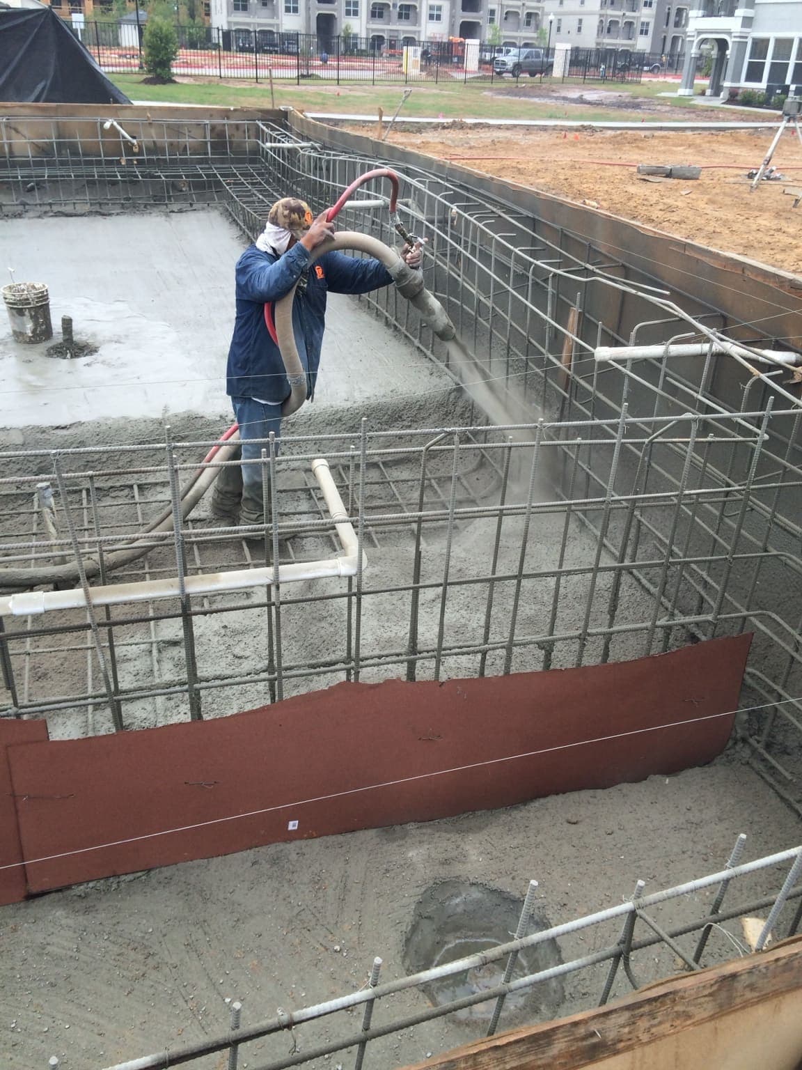 Crew applying structural shotcrete on a commercial project